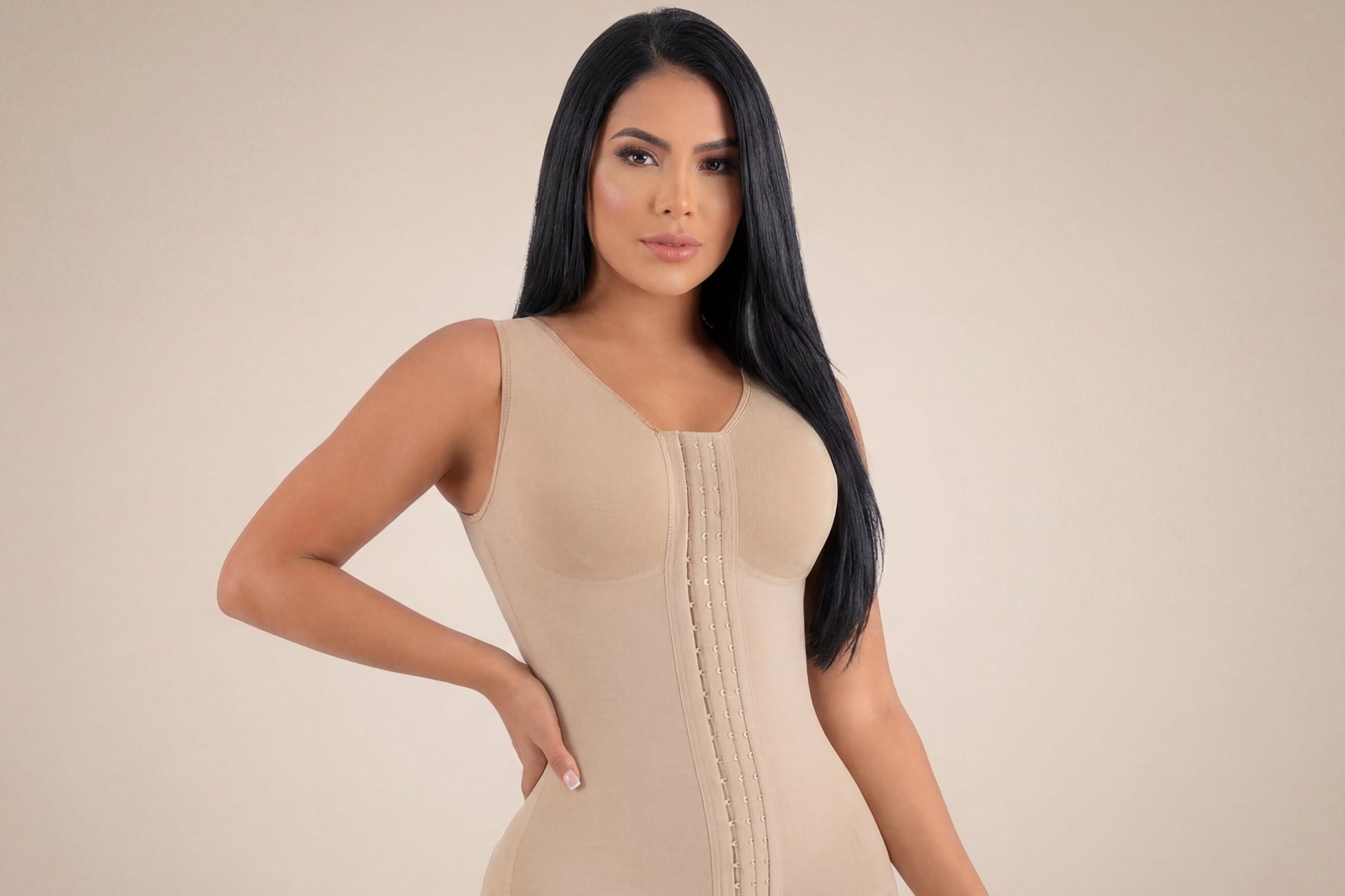 Woman wearing a beige shapewear garment on a beige background